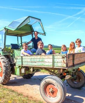 Urlaub auf dem Bauernhof für Kinder. Traktorfahrt auf dem Ferienhof Angermüller